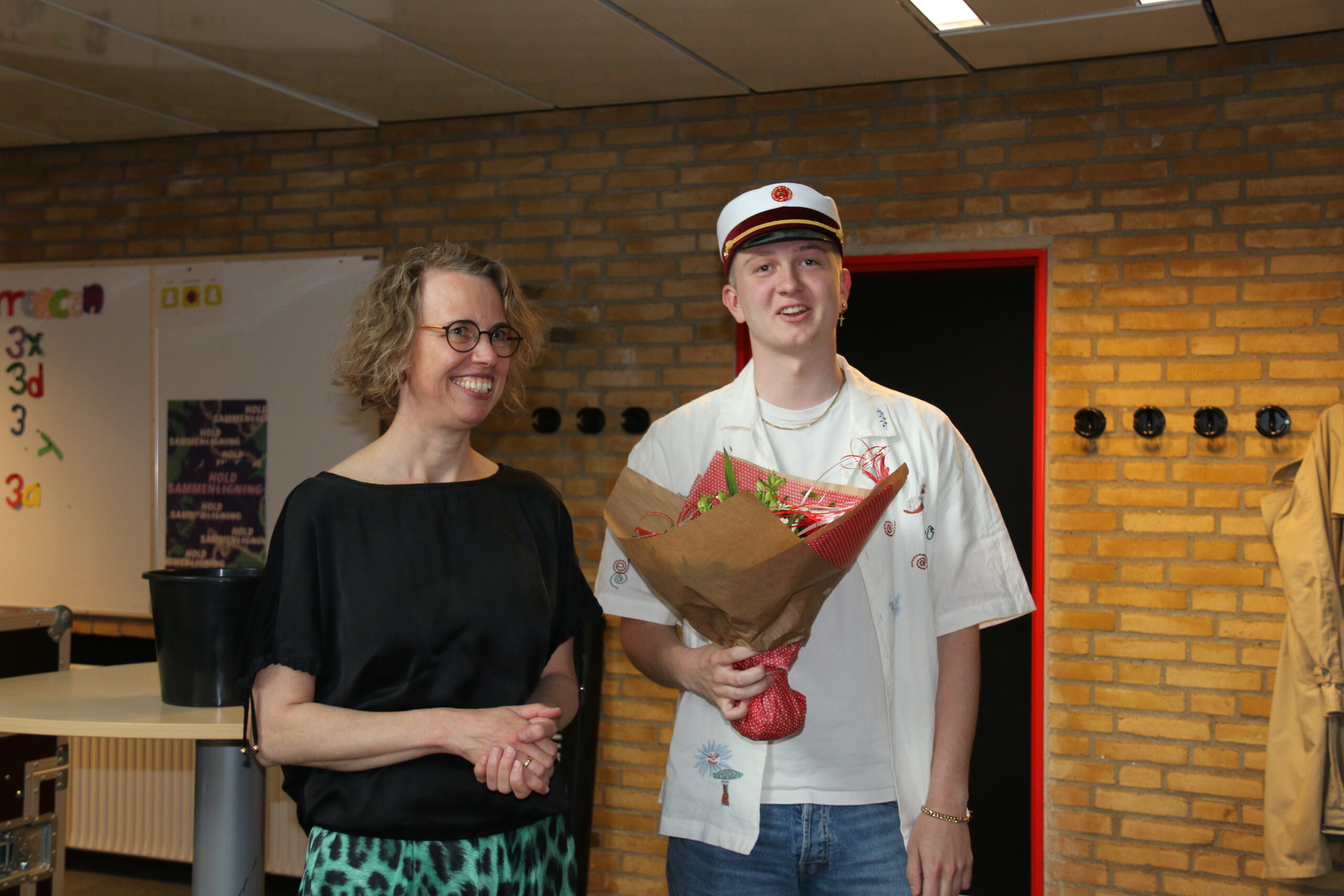 Årets første student Albert fra 3.b modtager blomster fra skolens rektor